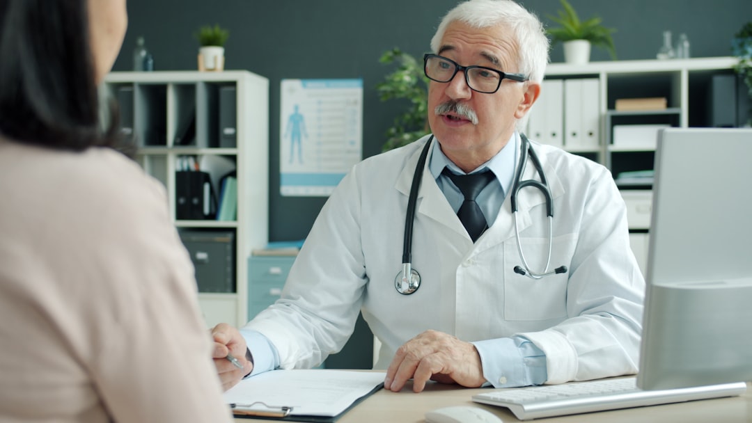 Doctor discussing knee osteoarthritis treatment options with a patient