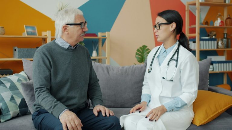 Healthcare provider speaking with patient about genicular artery embolization for knee osteoarthritis pain