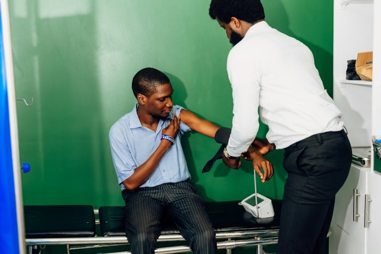 Patient in healthcare clinic during evaluation for knee pain with a specialist