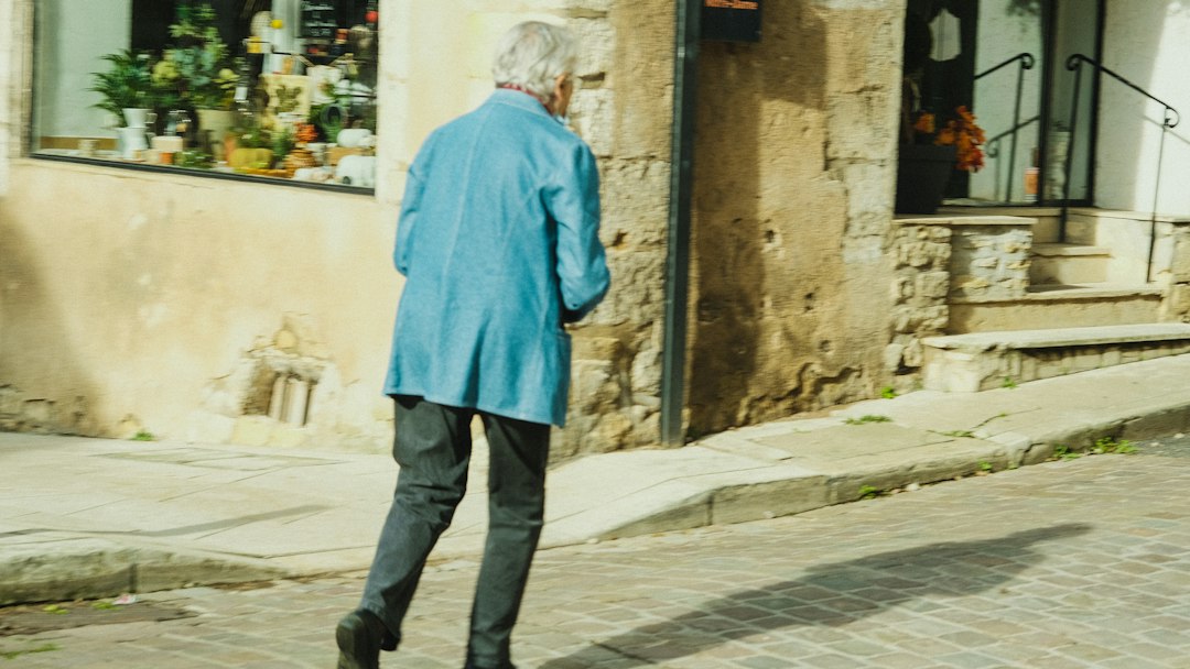 Person walking outdoors representing knee pain on one side of the joint